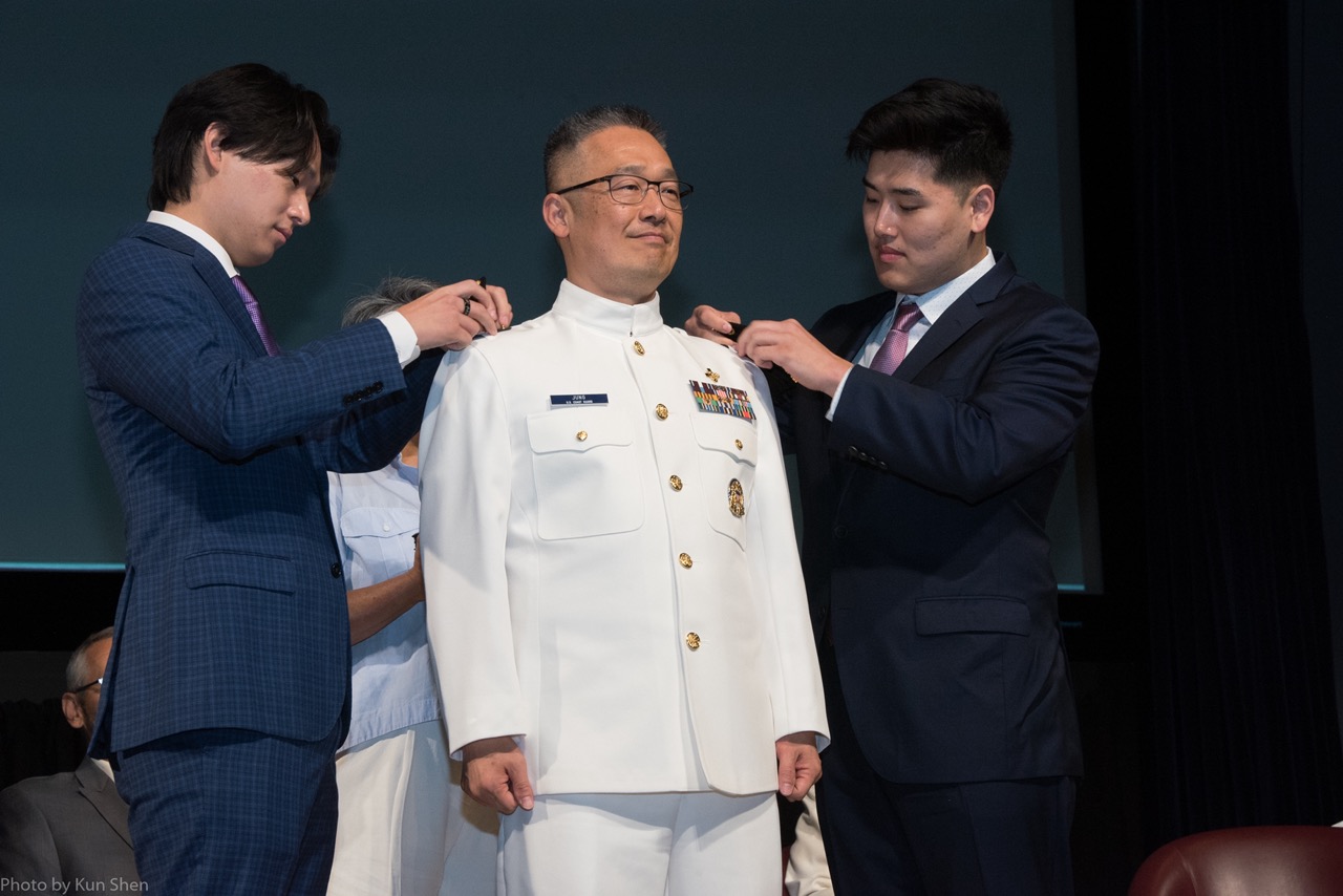 Dr. Jung with his sons, putting on his rank.